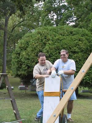 Augustus Chandler, moving the new headstone into position