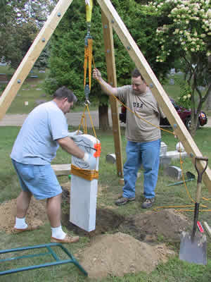 Augustus Chandler, lowering the new headstone into place